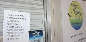 A sign outside the door of Sea 2 Sky Travel Agency in August 2012 telling customers to go to police about delinquent tickets. - PHOTO: STUART WILSON