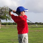 Justin, 9, tees up