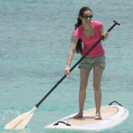 Paddle boarders storm the beach