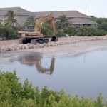 Workers ‘de-muck’ Brac pond