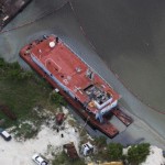 Oil-leaking dredger removed from North Sound
