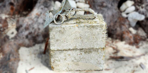 Handcuffs attached to a cement block was found off Seven Mile Beach last week.