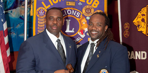 The new Lion President Ewan Jacques is welcomed by Immediate Past President  Rayle Roberts.