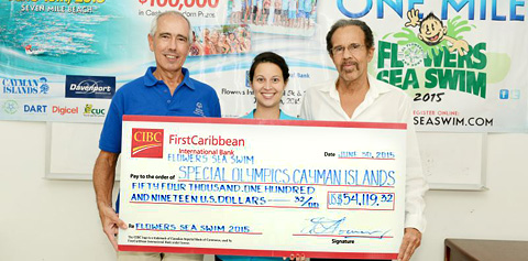 Nick Freeland, left, receives the check from Dara Flowers-Burke and Frank Flowers.