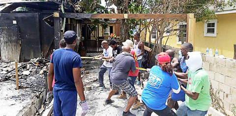 Volunteers on Sunday cleared what was left of the burned-out building.