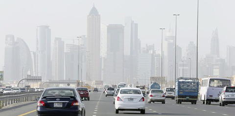 Cars pass by the Business Bay Tower in Dubai, United Arab Emirates.