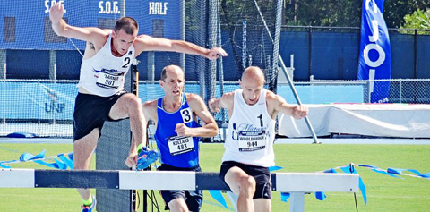 Larner, left, tackles the steeplechase hurdles at the USA Track and Field Masters.