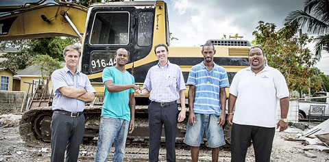 A community construction team including architect Eduardo Bernal, Alwin Buttrum, Garth Arch, Johnny Buttrum and Matthew Leslie aims to rebuild thefire-stricken home by Christmas.