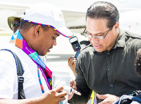 Premier Alden McLaughlin admires Special Olympian Mark Ebanks