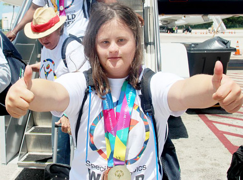 Two thumbs up from Special Olympian Kanza Bodden, who won three medals - one gold and two bronze. - PHOTO: RON SHILLINGFORD