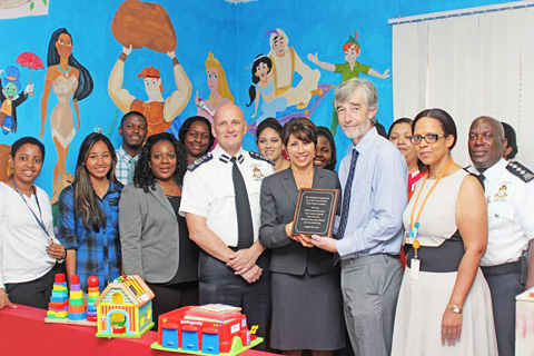Court Administrator Kevin McCormac presents the Health Services Authority’s CEO Lizzette Yearwood with a plaque for the Children’s Corner