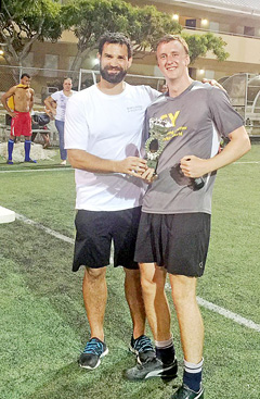 Tournament organizer Tom Elliot, left, presents Ernst & Young captain Jack Armstrong with the Plate.