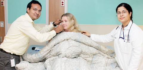 Technician Deepesh Vaidya, left, and Dr. Archita Joshi-Bhatt demonstrate the sleep lab technology on Health City staff member Lisa Burke. - PHOTO: JEWEL LEVY
