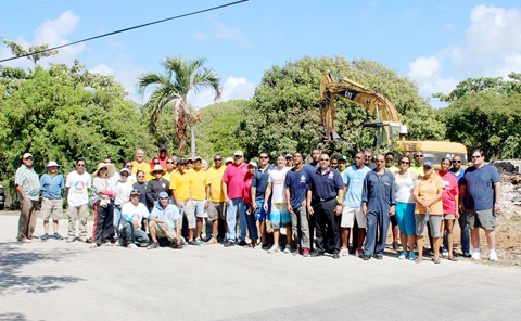 Some 60 volunteers were on hand to help clear the site of the burned-out house in Bodden Town on Saturday. – Photos: Jewel Levy
