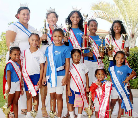International Girl pageant competitors pose with their trophies after returning to Cayman last week. - Photo: Jewel Levy