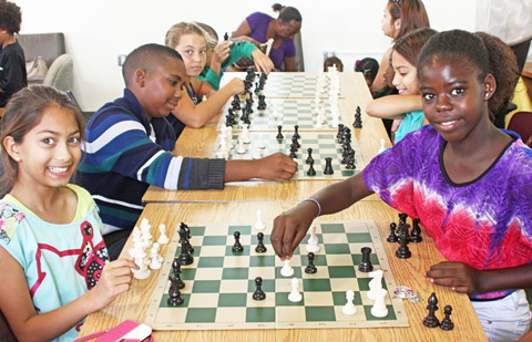 Youngsters enjoy playing chess at the George Town Public Library. - Photo: Jewel Levy