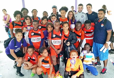 Coach Walter Hernandez, right, with the group that went to Orlando last month.