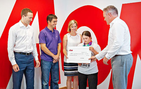 Ghislain Ghyoot, Chris Fenn, Stacey Ford and Adrian Lynch of Aon present Special Olympics athlete Kanza Bodden with Aon’s $5,000 donation.