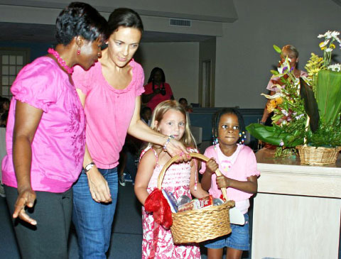 Youngsters and adults bring their baskets during last year’s harvest festival. - Photo: Jewel Levy