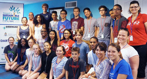 Students, with presenters and facilitators, celebrate the hosting of UWC