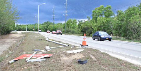 A Friday night accident knocked over a lightpole and the ‘For heaven’s sake, don’t overtake!’ sign on the Esterley Tibbetts Highway. - Photo: Charles Duncan