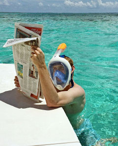 One of the couple’s friends reads his paper through a full-face snorkel mask.