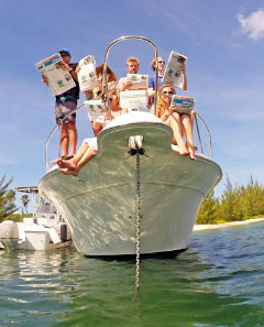Friends of Gemma and Richard pose on board a boat with the Compass for the couple