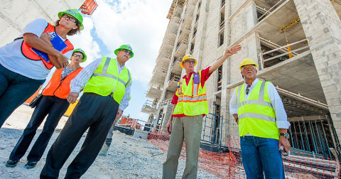 Kathy Jackson, Christine Maltman, McKeeva Bush, Lee Hudson and Ken Hydes survey the Kimpton hotel site. – Photo: Taneos Ramsay