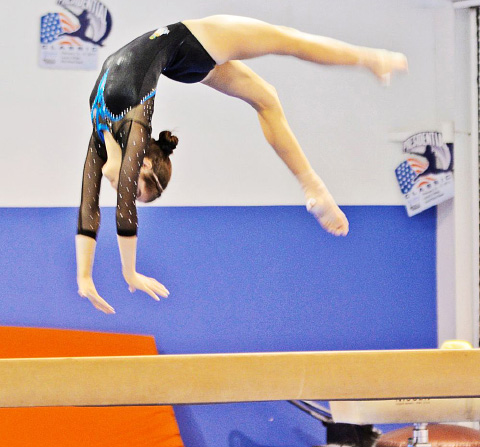 Raegan Rutty demonstrates her flexibility and agility on the beam.