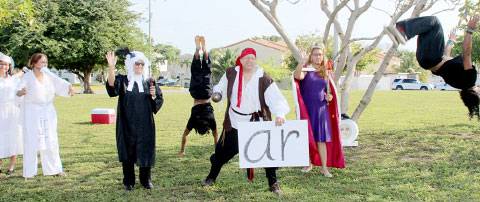 Vinnette Mae Glidden, far left, and her husband Charles Glidden, in pirate costume, along with gymnasts from Flo-Motion and supporters at the Kings roundabout on Monday morning. - PHOTO: JEWEL LEVY