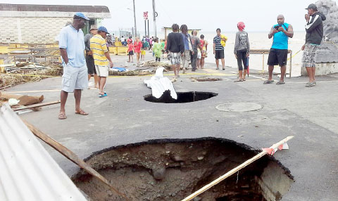 Tropical Storm Erika caused major damage in Dominica, including sinkholes in this road next to the capital Roseau’s main market. - PHOTO: AP