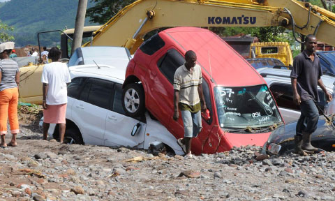 Tropical Storm Erika caused widespread damage in Dominica. Here vehicles can be seen damaged in a packing lot in Massacre on Dominica