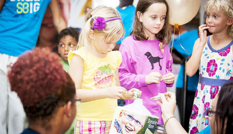 Kids line up to make donations.