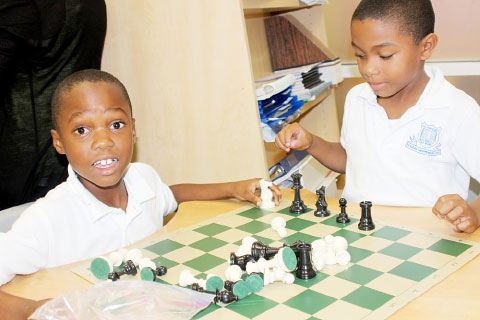 Isaiiah Bush looks to take Okenie Mclaughlin’s knight during a game at George Town Primary School. – Photo: Jewel Levy