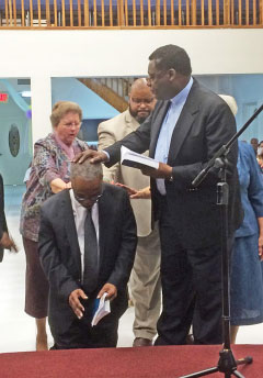 Rev. Joel Cumberbatch ordains Rev. Doughlin in George Town