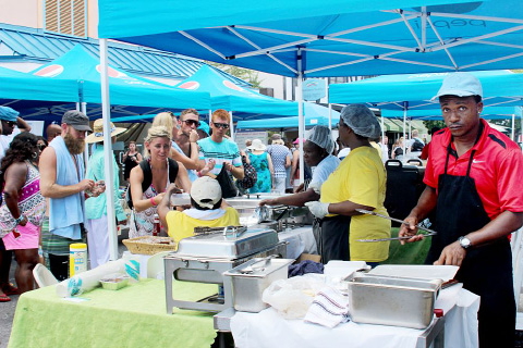 Cruise ship passengers purchase local food at Yolanni