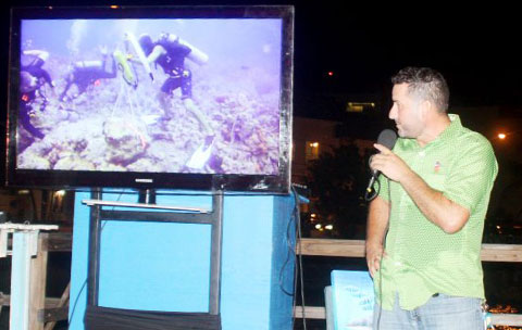 Joe Avary shows a video highlighting the work that has been done to restore the ‘Magic Reef’ at Cayman Cabana on Friday night. – PHOTO: NORMA CONNOLLY