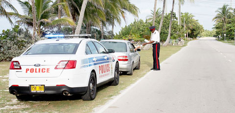 PC Harvel Grant issues a ticket during a traffic stop on Rum Point Road. - PHOTO: RCIPS