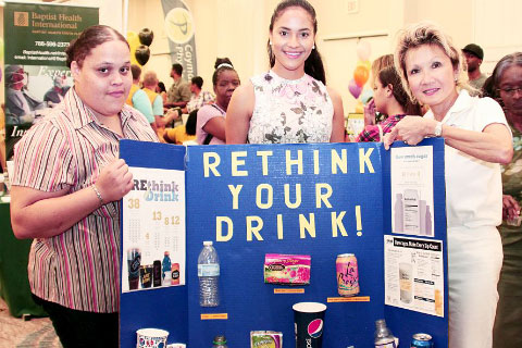 From left, Brennita Palmer, Samantha Rea and Dr. Sook Yin highlight the dangers of too much sugar at the Conquering Cancer health fair at the Marriott Beach Resort on Saturday. – Photos: Jewel Levy