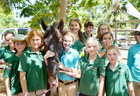 Students of Cayman Riding School visit Bandy at his new home last Saturday.