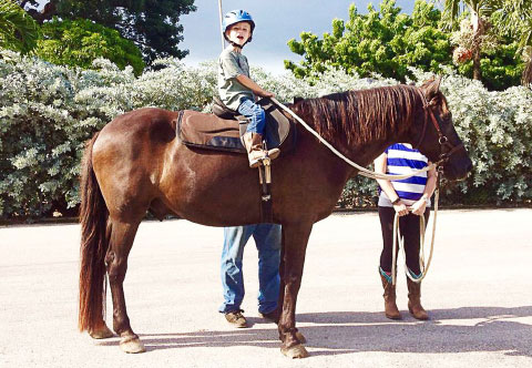 Bandy takes a Cowboy Town Stables rider for a ride.