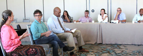 Panelists, from left, Julene Banks, Bruce Shapiro and Dr. Marc Lockhart speak to a group of local journalists and other media professionals at a Dart Center for Journalism and Trauma conference