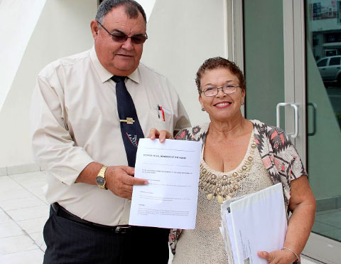 North Side MLA Ezzard Miller accepts a petition from Andrea Martinez-Calderon