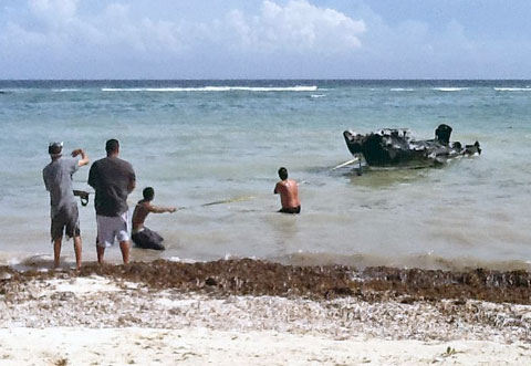 Residents pull the ashore.