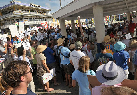 Protesters on Saturday gathered to listen to those speaking out against the proposed dock project. – Photo: Alan Markoff