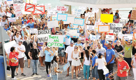 Between 250 and 300 people, many of them holding placards, protested the proposed cruise ship berthing facility at the George Town waterfront on Saturday. – Photo: Alan Markoff