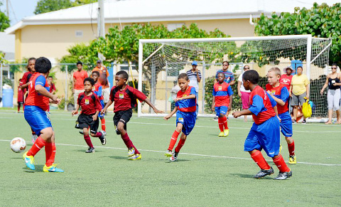 Red Bay’s Isaac Peart (center maroon) scored against Triple C in the U- 9 game.