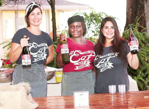 Ally Manning, Charmane Black and Claire Scott offer Kombucha at one of the many stations at Saturday