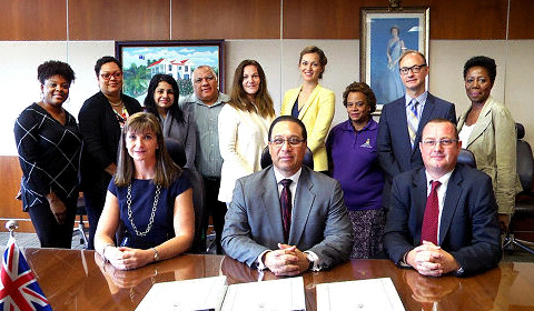 Premier Alden McLaughlin, seated between Chief Officer Jennifer Ahearn and Kris Beighton for KPMG, at the contract signing with KPMG earlier this month.