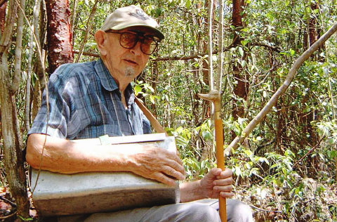 George Proctor, pictured on the Mastic Trail in 2004, with his vasculum, a botanical box used for holding field samples.